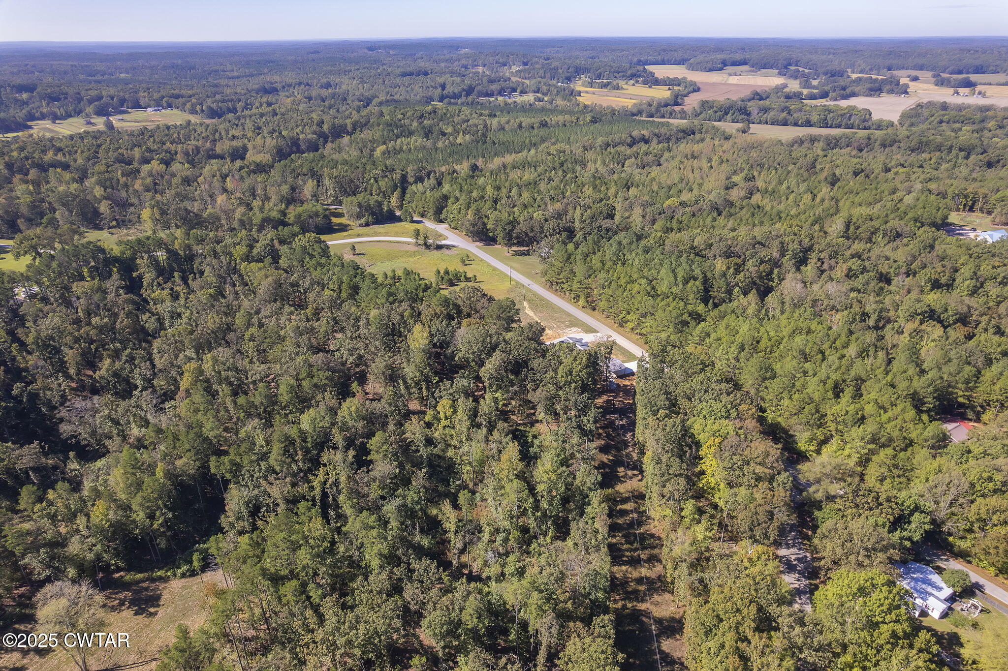 2885 Old Friendship Road Finger, TN 38334 - Photo 46 of 50 an aerial view of a houses with a lush green hillside
