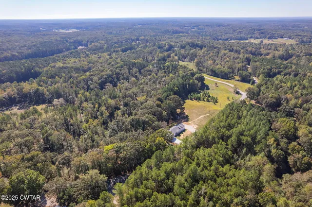 an aerial view of residential house and sandy dunes