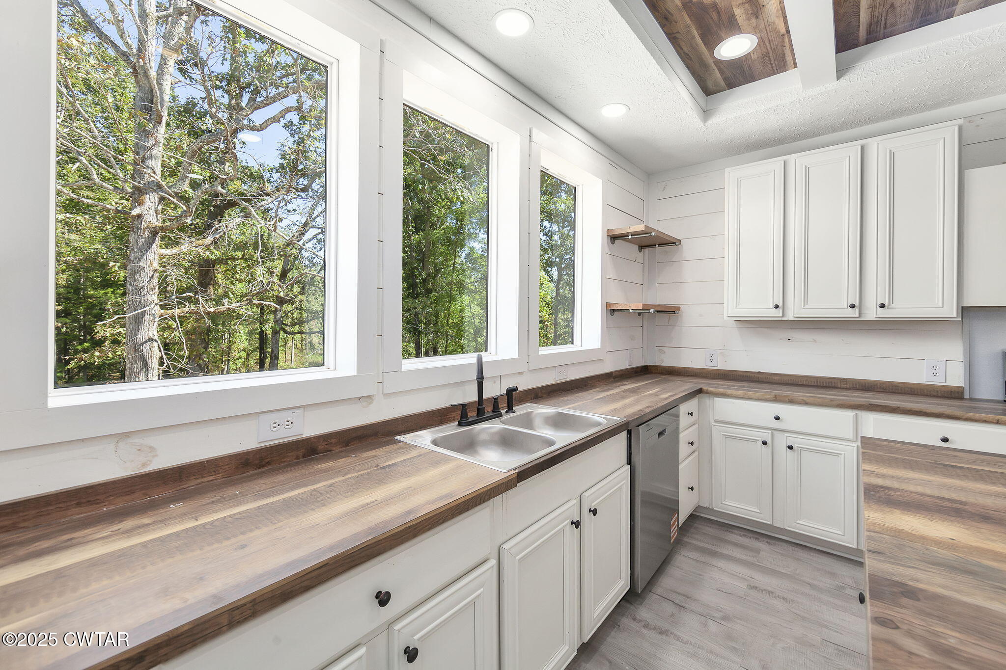 2885 Old Friendship Road Finger, TN 38334 - Photo 10 of 50 a kitchen with granite countertop white cabinets and a large window