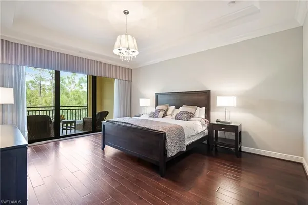 a bedroom with a large bed and a large window