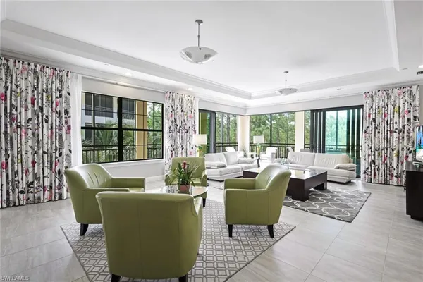 a living room with furniture and large windows