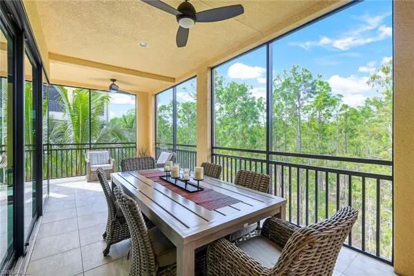 a view of a patio with a table chairs and a backyard