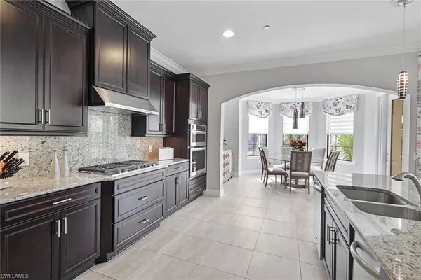 a kitchen with stainless steel appliances granite countertop a sink and cabinets