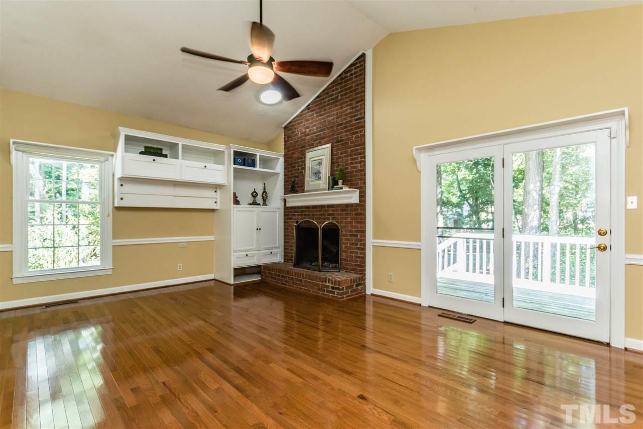 5606 Red Coach Road Durham, NC 27712 - Photo 11 of 25 a view of an empty room with a window and wooden floor