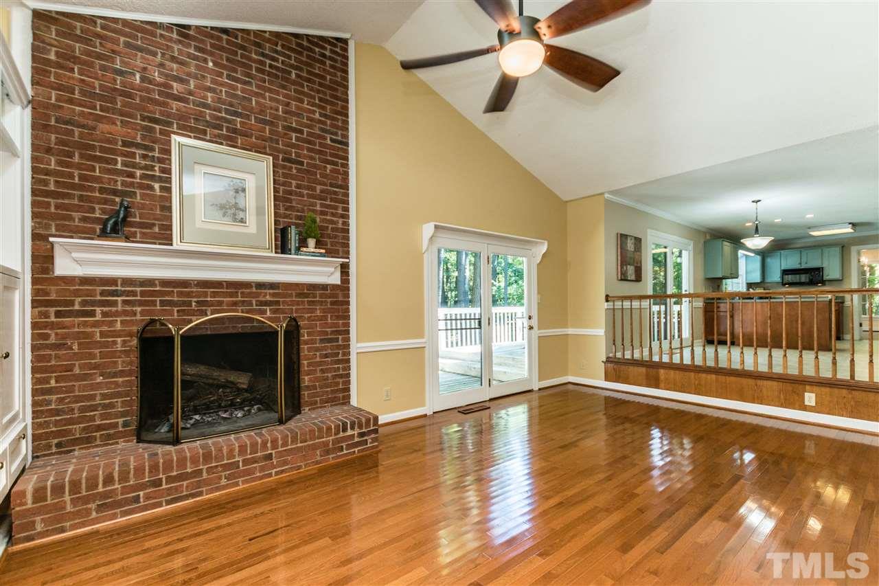 5606 Red Coach Road Durham, NC 27712 - Photo 12 of 25 a view of a livingroom with wooden floor and a fireplace