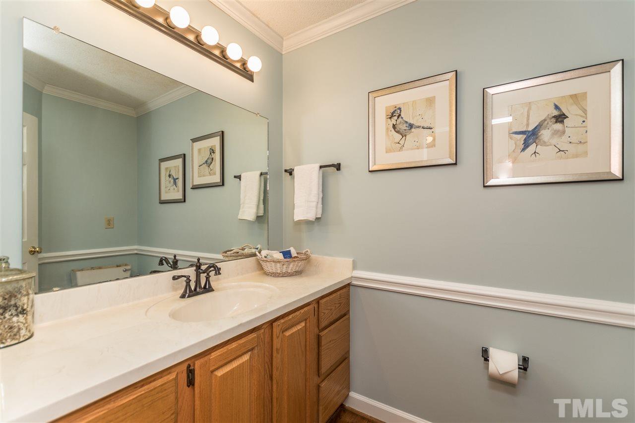 5606 Red Coach Road Durham, NC 27712 - Photo 13 of 25 a bathroom with a sink vanity and a mirror