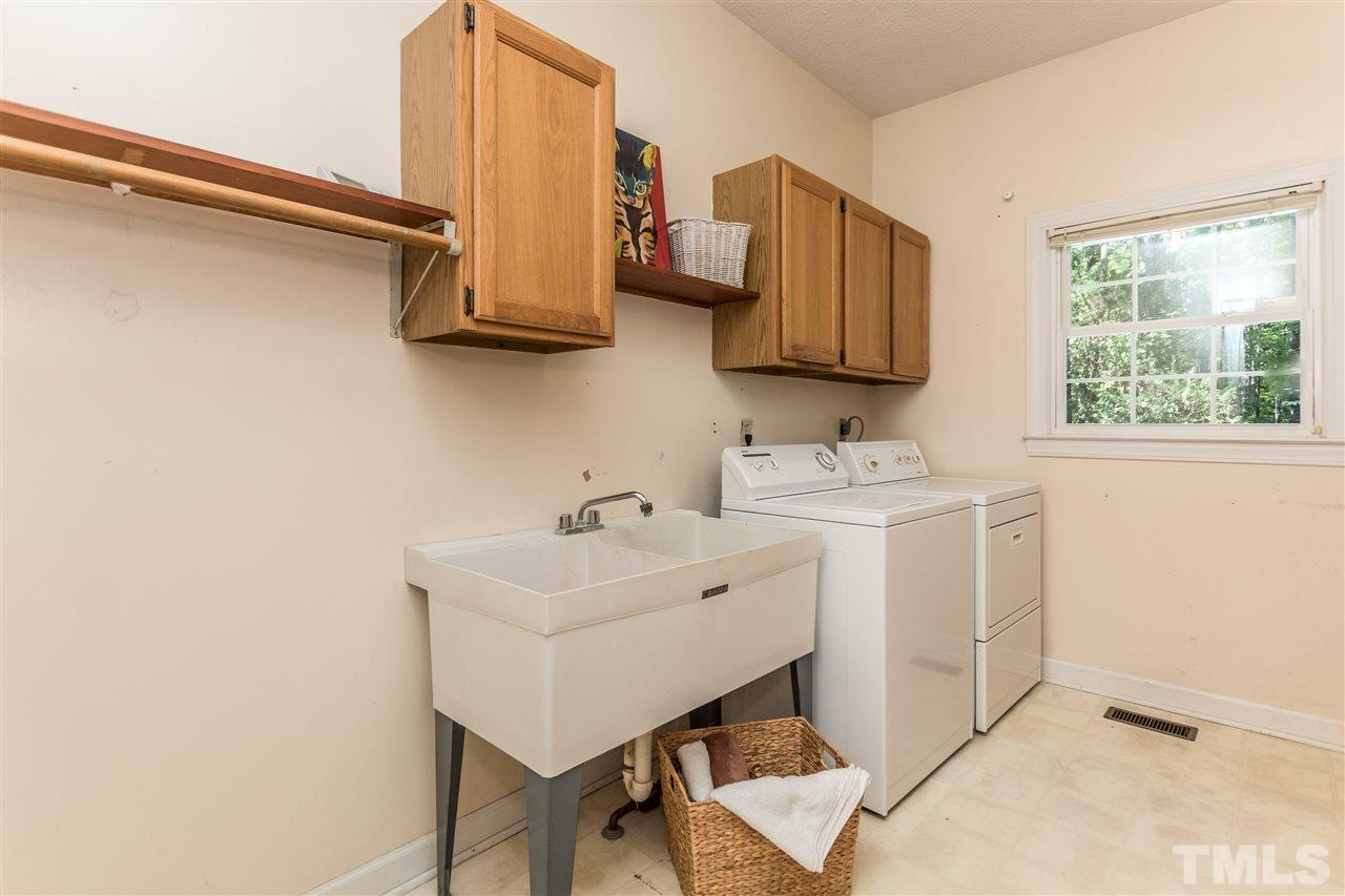 5606 Red Coach Road Durham, NC 27712 - Photo 14 of 25 a bathroom with a sink a mirror and a window