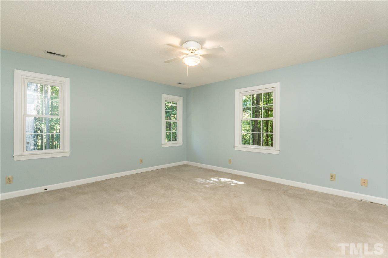 5606 Red Coach Road Durham, NC 27712 - Photo 15 of 25 an empty room with windows and chandelier fan