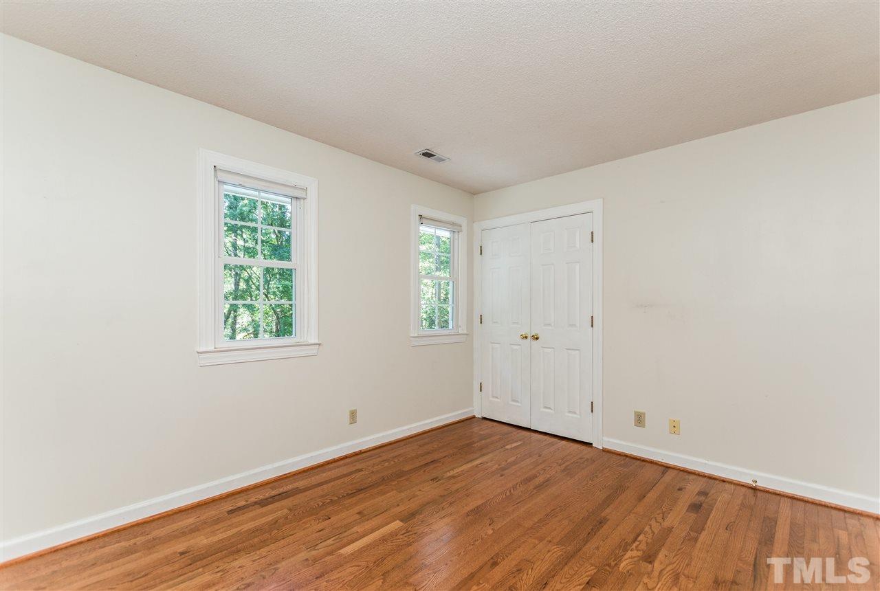 5606 Red Coach Road Durham, NC 27712 - Photo 18 of 25 an empty room with wooden floor and windows