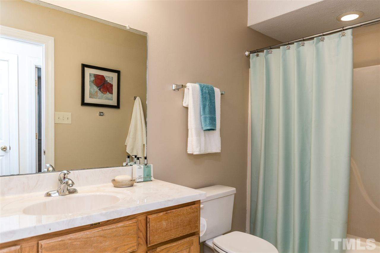 5606 Red Coach Road Durham, NC 27712 - Photo 20 of 25 a bathroom with a sink vanity mirror and toilet