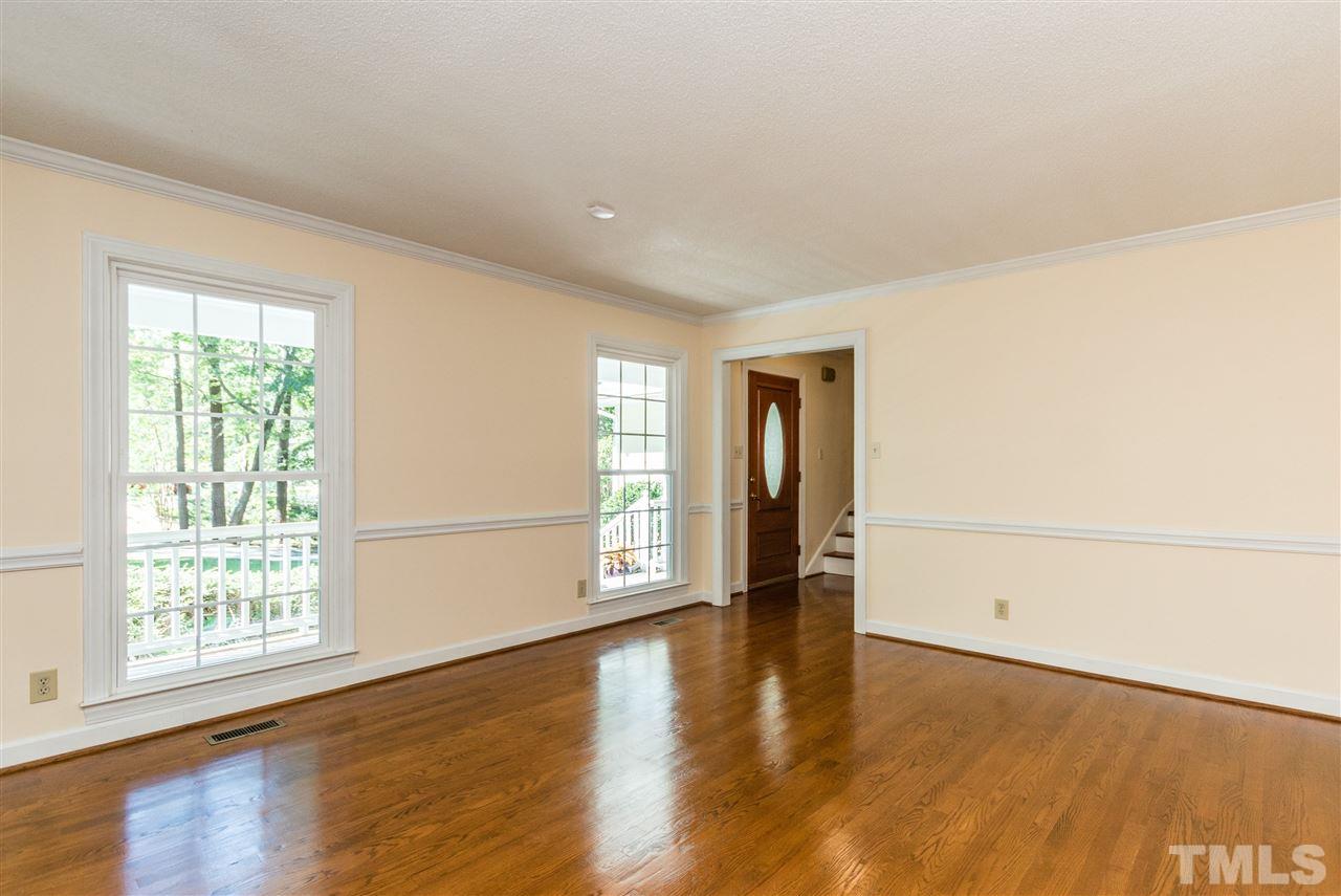 5606 Red Coach Road Durham, NC 27712 - Photo 4 of 25 a view of an empty room with wooden floor and a window