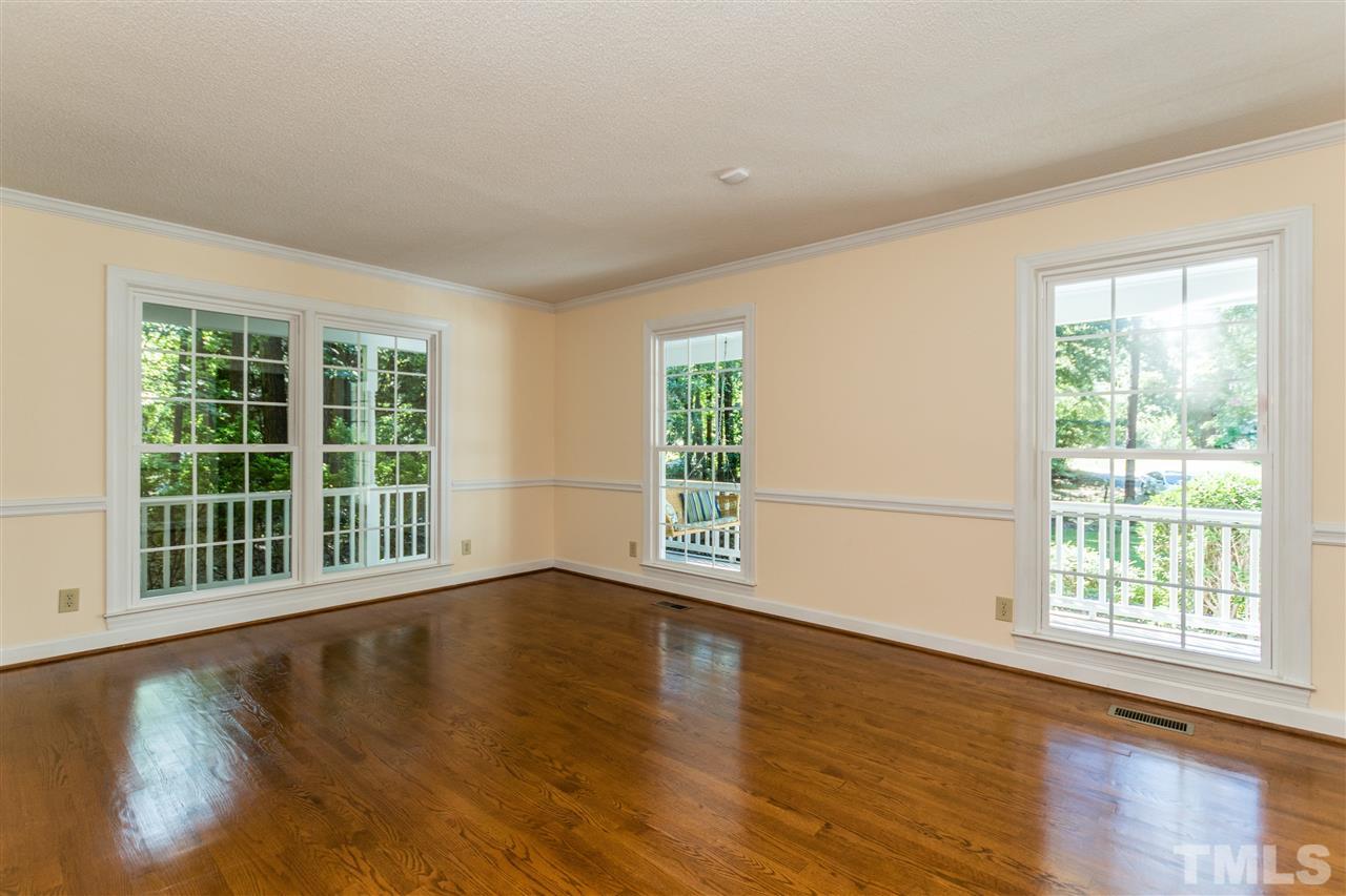 5606 Red Coach Road Durham, NC 27712 - Photo 5 of 25 a view of an empty room with wooden floor and a window