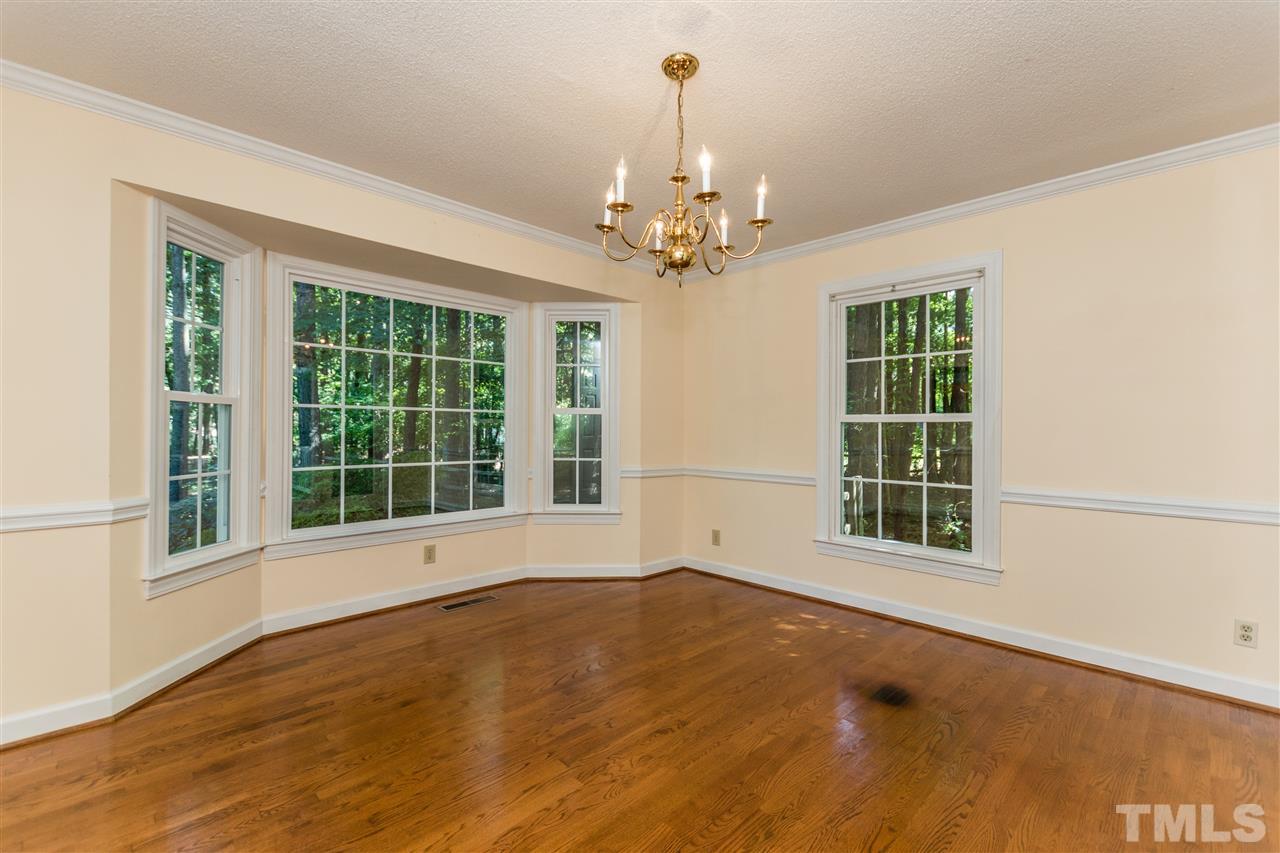5606 Red Coach Road Durham, NC 27712 - Photo 6 of 25 a view of an empty room with a window and wooden floor