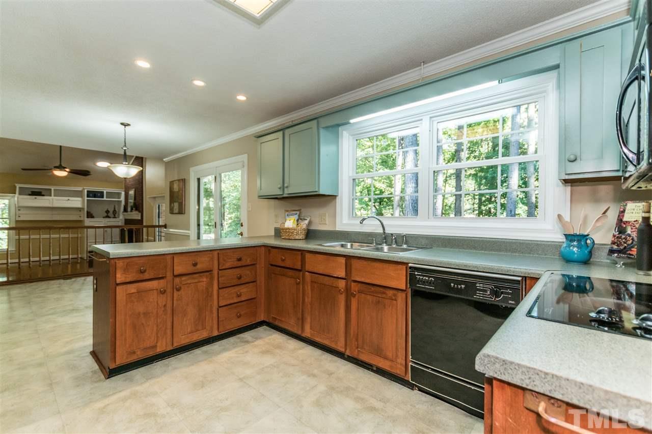 5606 Red Coach Road Durham, NC 27712 - Photo 8 of 25 a kitchen with stainless steel appliances granite countertop a sink stove and cabinets