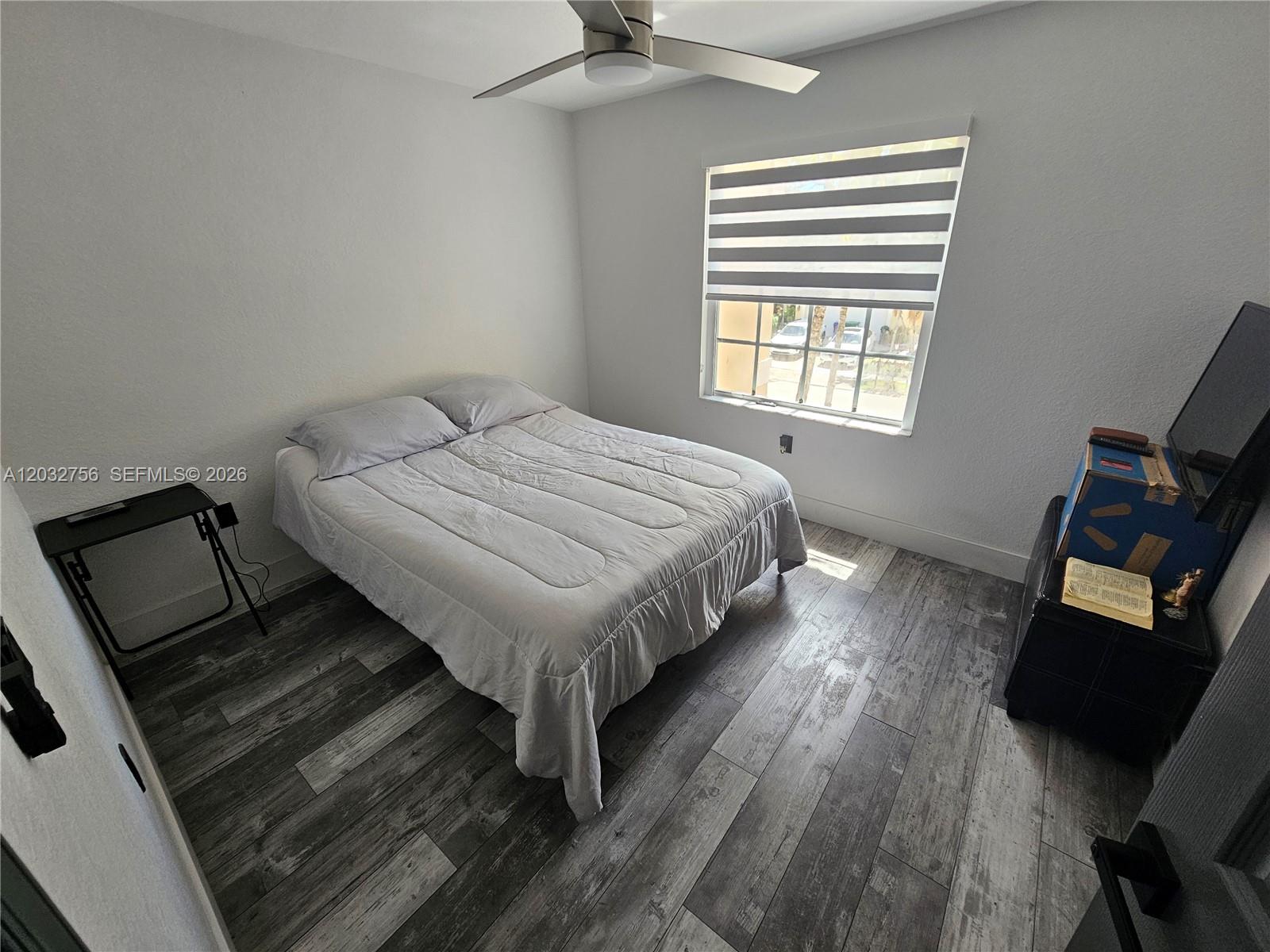 4331 Southwest 124th Way Miramar, FL 33027 - Photo 20 of 40 a spacious bedroom with a bed and wooden floor