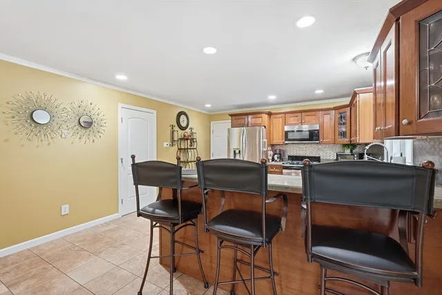 a kitchen with a table chairs refrigerator and chairs