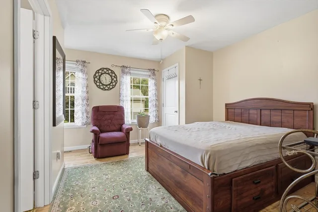 a bed room with a bed and a chair