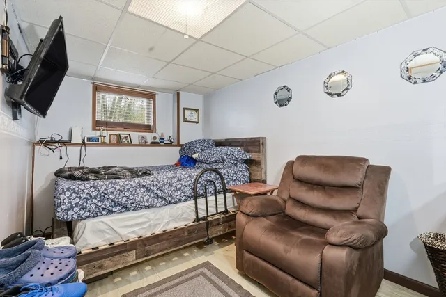 a bedroom with furniture and a flat screen tv