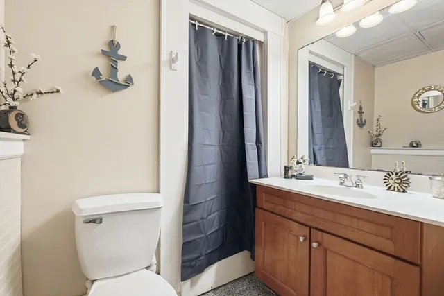 a bathroom with a sink a toilet and mirror