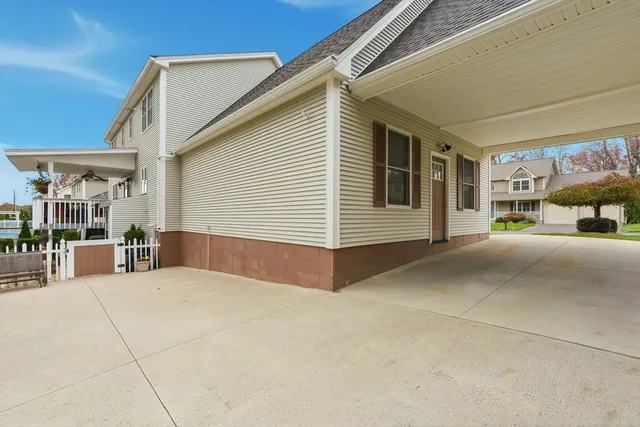 a view of a house with a small yard and wooden fence