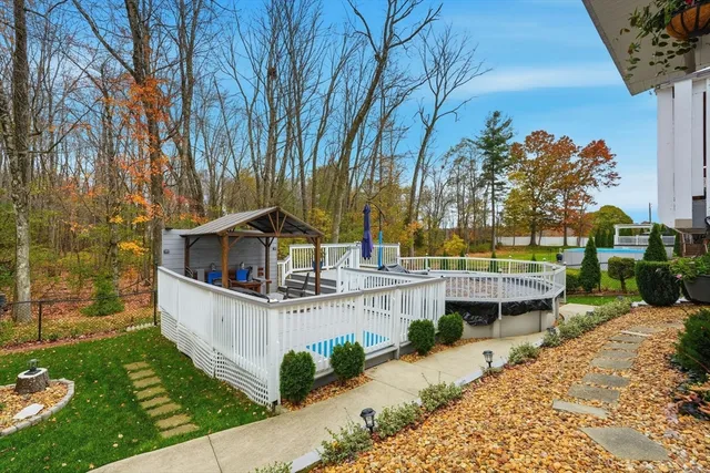 a view of a wooden deck and a backyard