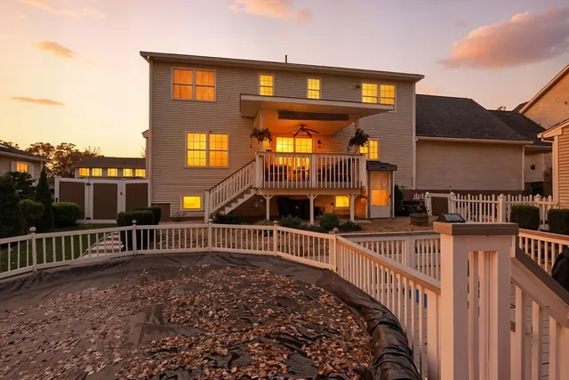 a view of a brick house with large windows and a small yard