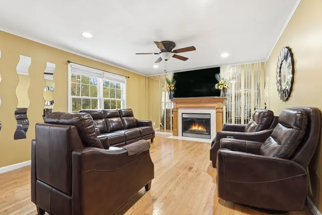 a living room with furniture a fireplace and a flat screen tv