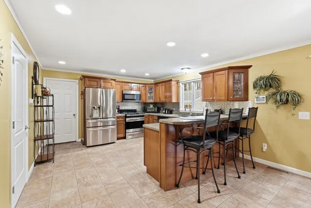 a kitchen with stainless steel appliances a refrigerator and a stove top oven