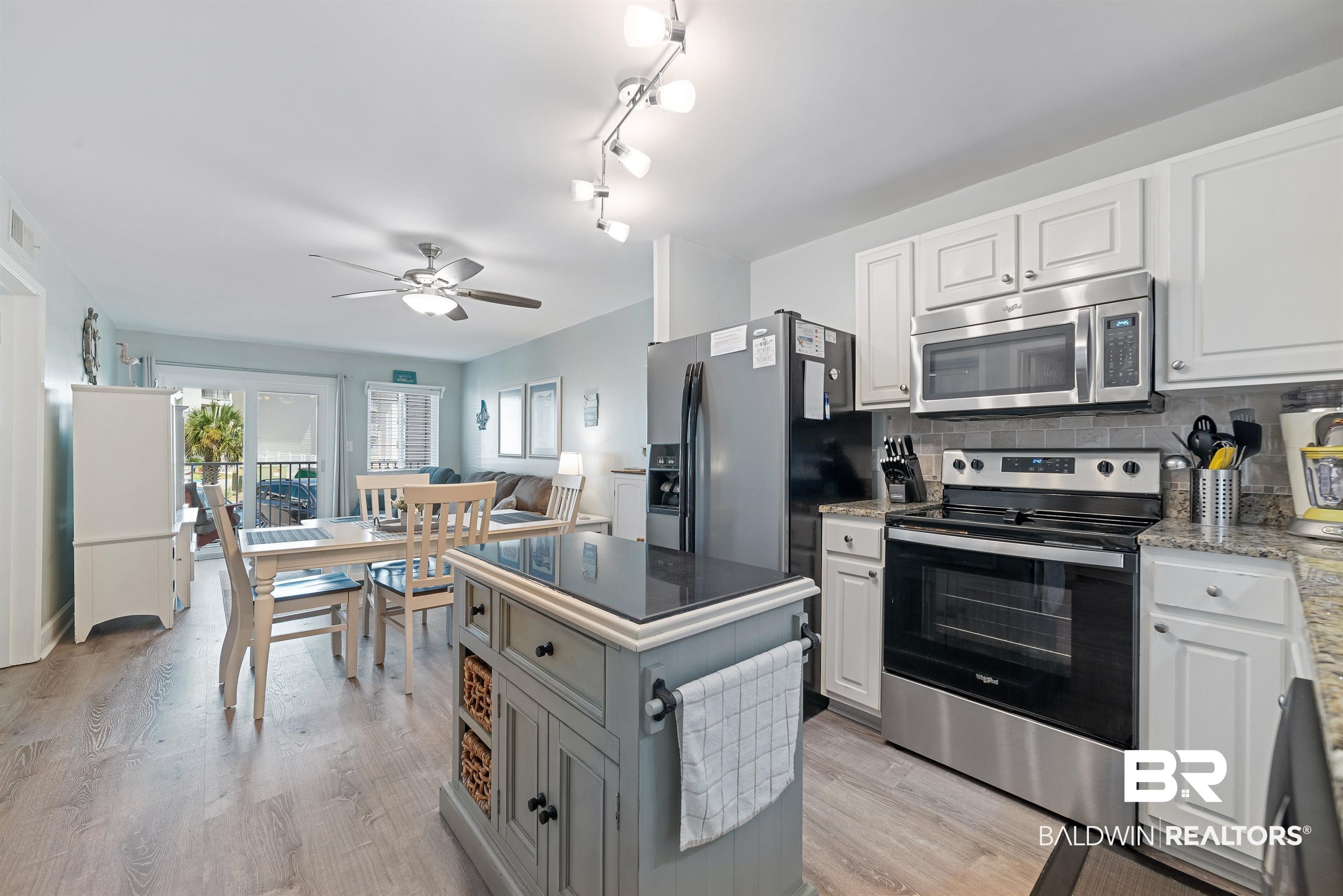 400 Plantation Road, Unit 2123 Gulf Shores, AL 36542 - Photo 3 of 44 Kitchen featuring light hardwood / wood-style floors, appliances with stainless steel finishes, white cabinets, and rail lighting