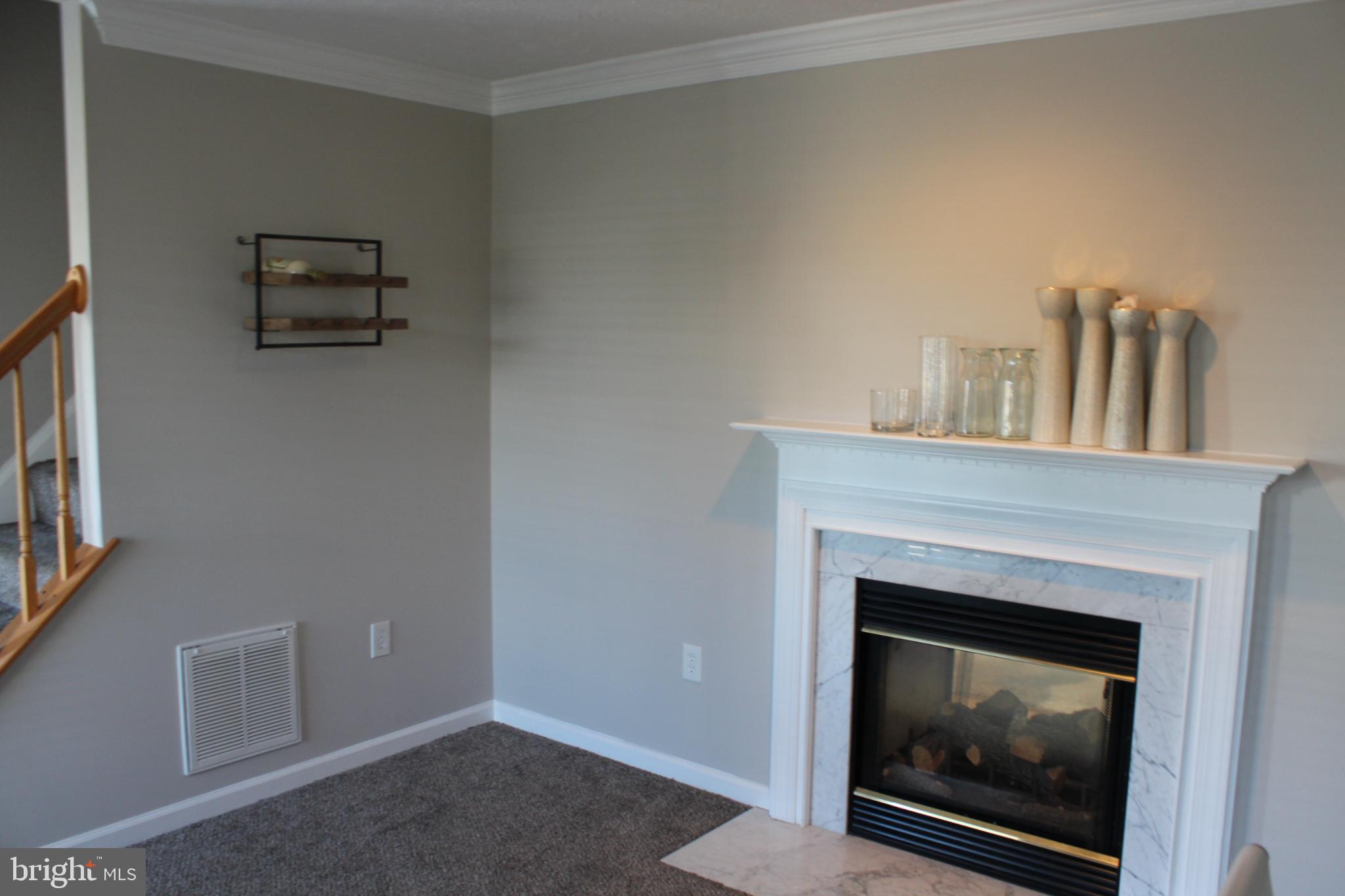107 Fancy Court Stephens City, VA 22655 - Photo 11 of 36 a living room with furniture and a fireplace