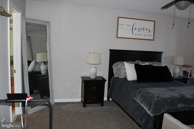 a bed room with a bed and painting on the wall