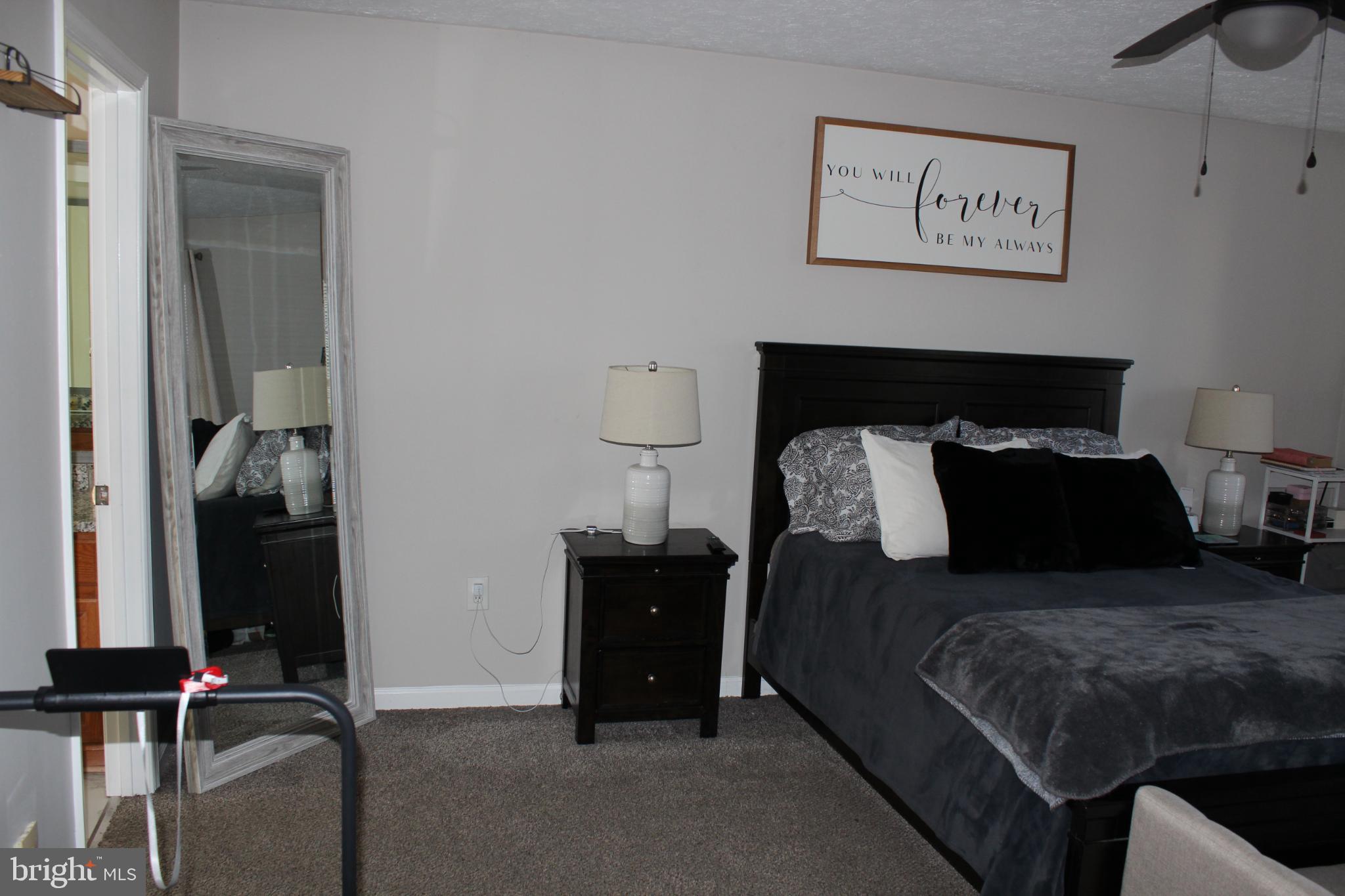 107 Fancy Court Stephens City, VA 22655 - Photo 14 of 36 a bed room with a bed and painting on the wall