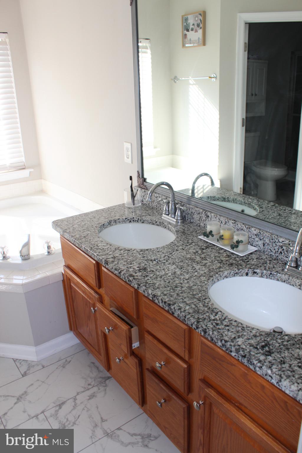 107 Fancy Court Stephens City, VA 22655 - Photo 15 of 36 a bathroom with a granite countertop sink and a mirror