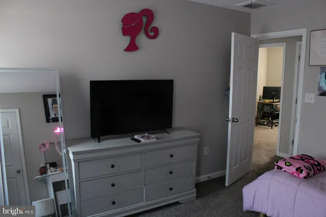 a living room with furniture and flat screen tv