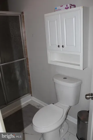 a white toilet sitting next to a bathroom sink