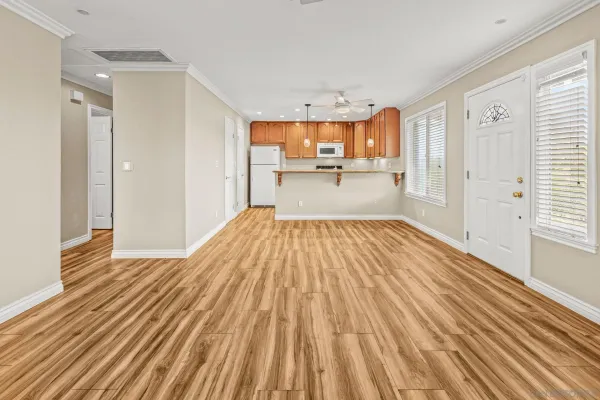 a view of a living room hardwood floor and a window