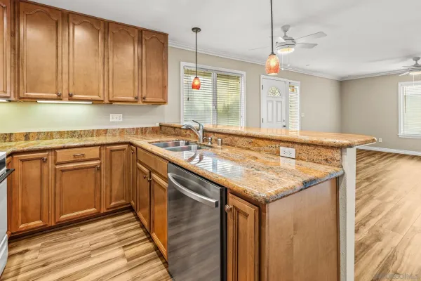 a kitchen with stainless steel appliances granite countertop a sink and cabinets