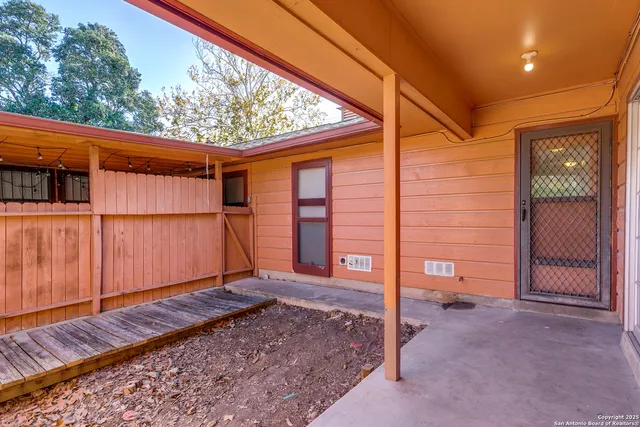 an empty room with wooden floor and a window