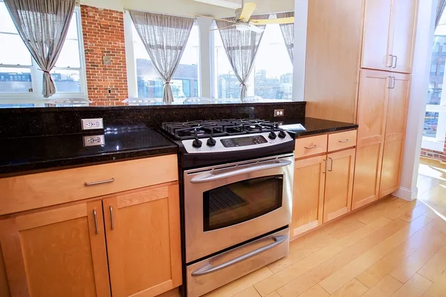 a stove top oven sitting inside of a kitchen