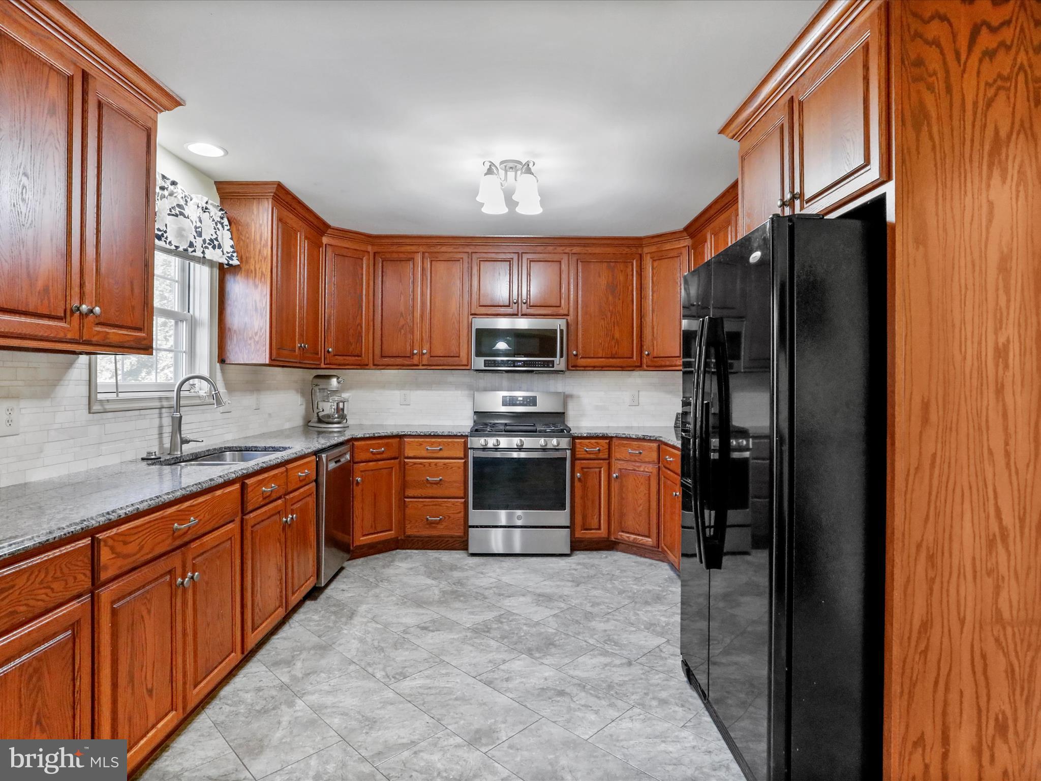 8297 Stottlemyer Road Waynesboro, PA 17268 - Photo 11 of 51 a kitchen with stainless steel appliances granite countertop a refrigerator stove and sink