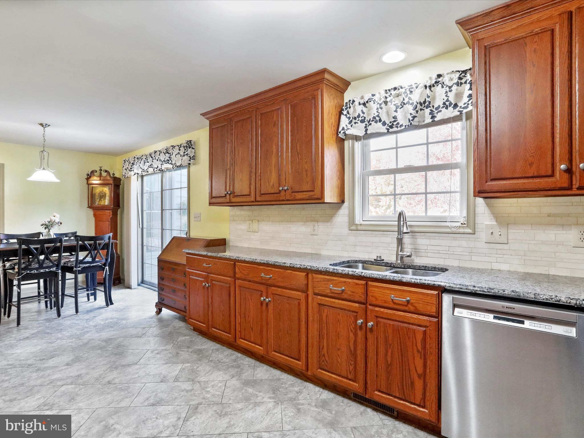 8297 Stottlemyer Road Waynesboro, PA 17268 - Photo 13 of 51 a kitchen with stainless steel appliances granite countertop wooden cabinets a dining table and chairs