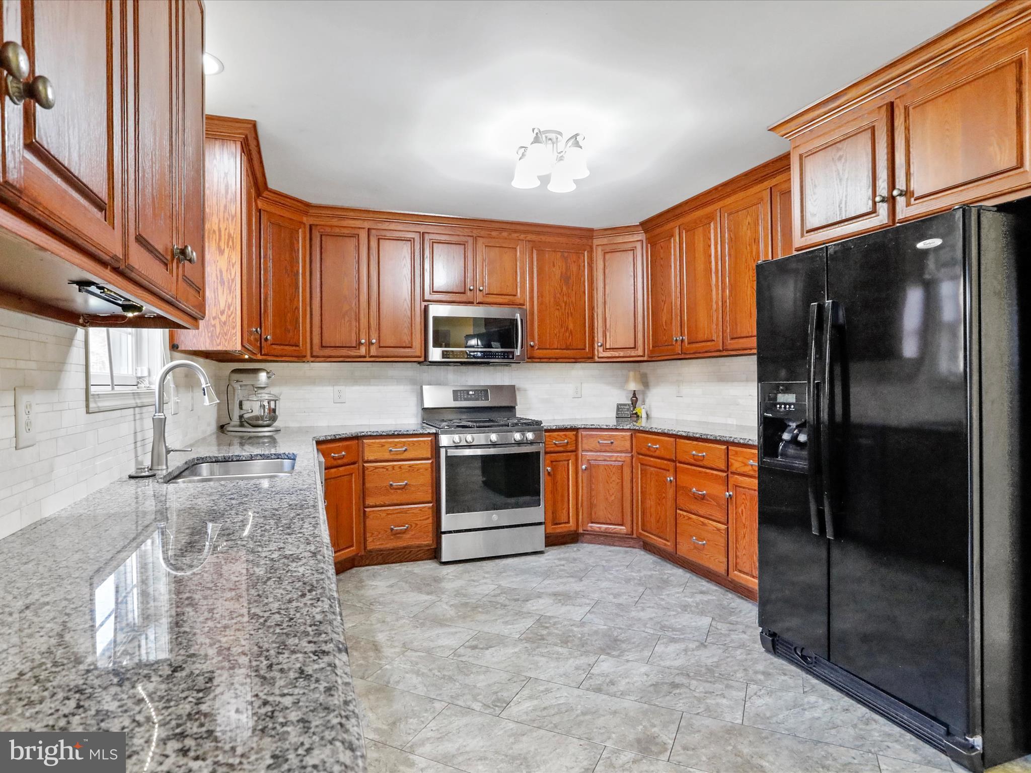 8297 Stottlemyer Road Waynesboro, PA 17268 - Photo 14 of 51 a kitchen with stainless steel appliances granite countertop a refrigerator stove top oven a sink and dishwasher