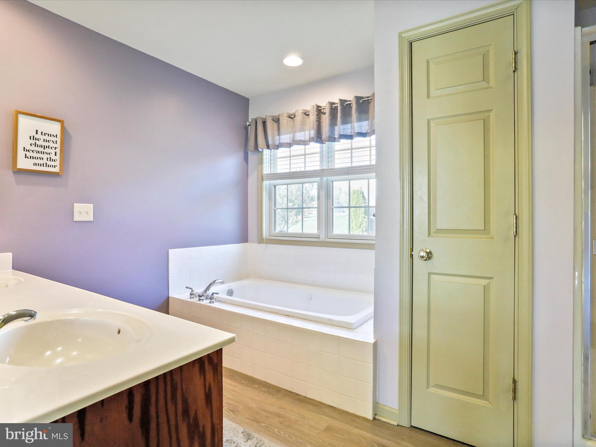 8297 Stottlemyer Road Waynesboro, PA 17268 - Photo 21 of 51 a bathroom with a sink a bathtub and a window