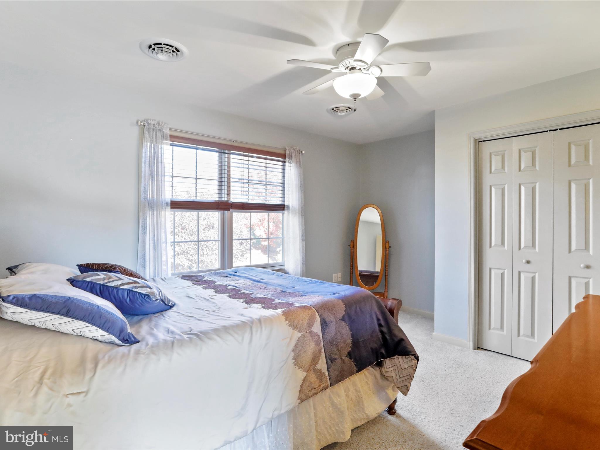 8297 Stottlemyer Road Waynesboro, PA 17268 - Photo 27 of 51 a bedroom with a large bed and a chandelier
