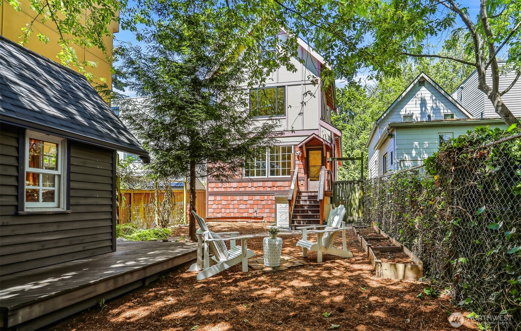 1749 Northwest 63rd Street Seattle, WA 98107 - Photo 27 of 40 a view of a patio with table and chairs and wooden fence