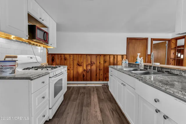 a kitchen with stainless steel appliances granite countertop a stove and a sink