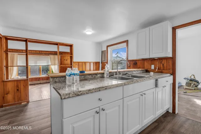 a kitchen with stainless steel appliances granite countertop a sink stove and cabinets