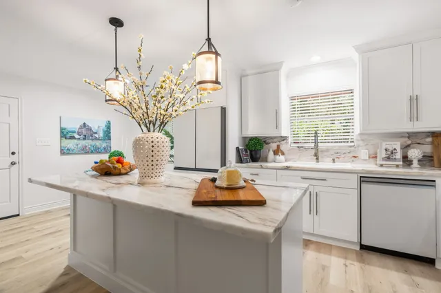a kitchen with a sink cabinets and window