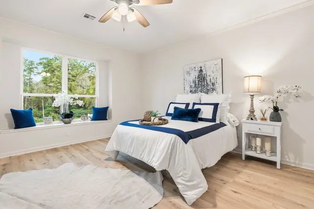 a bedroom with a large bed and a window