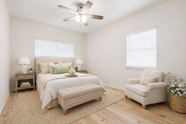 a bedroom with a bed and wooden floor